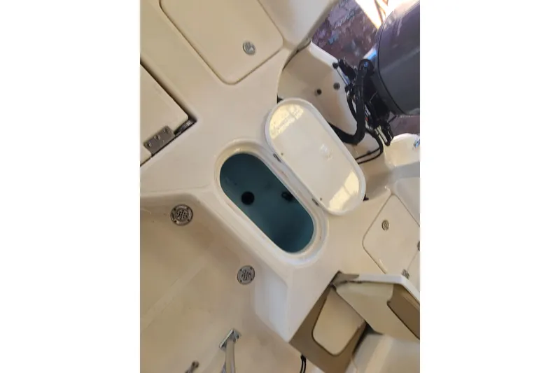 Slide: The Image of 2015 Pioneer 220 Bay Sport boat interior with open storage compartment. - 25