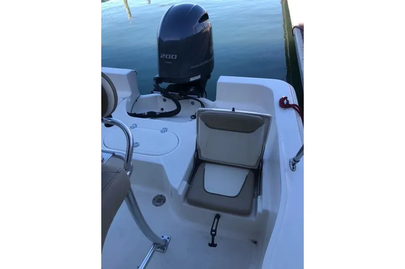 Slide: The Image of 2015 Pioneer 220 Bay Sport boat with Yamaha 200 engine, featuring seating and storage. - 27