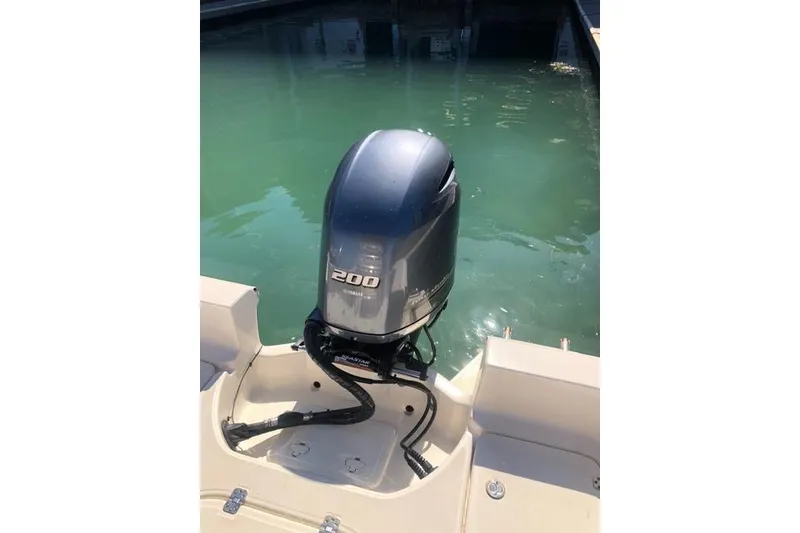 Slide: The Image of Outboard motor on 2015 Pioneer 220 Bay Sport boat, docked in clear water. - 28