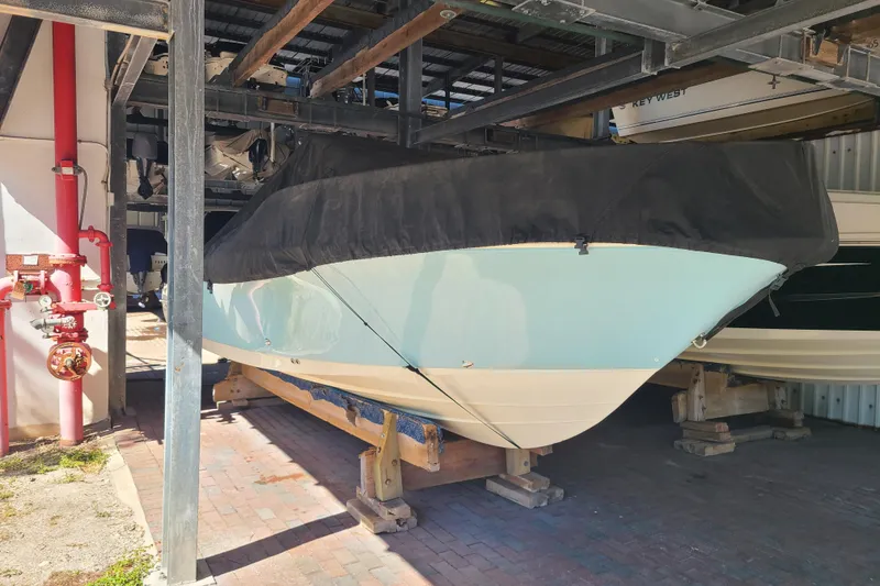 Slide: The Image of 2015 Pioneer 220 Bay Sport boat stored indoors with protective cover. - 30