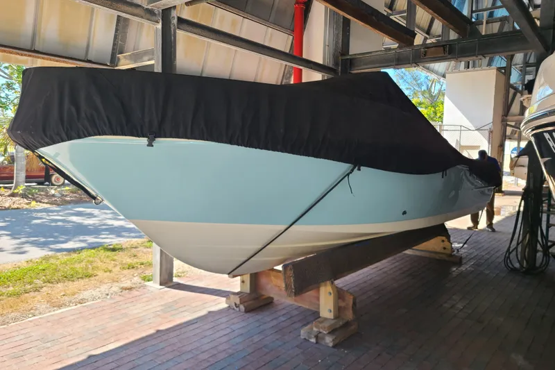 Slide: The Image of 2015 Pioneer 220 Bay Sport boat with cover, stored on wooden supports. - 31