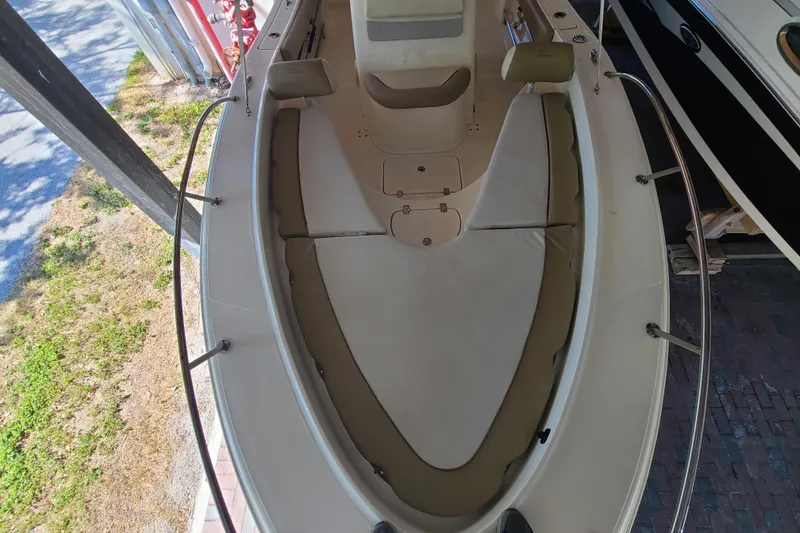 Slide: The Image of 2015 Pioneer 220 Bay Sport boat interior with cushioned seating and railings. - 9