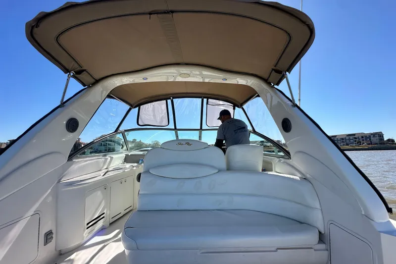 Slide: The Image of 2000 Sea Ray 340 Sundancer interior with seating and canopy on a sunny day. - 14