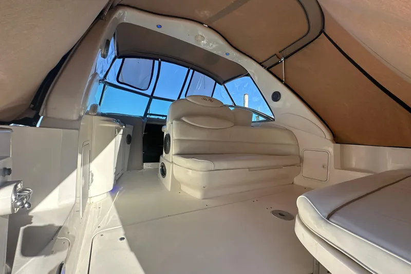 Slide: The Image of Interior of 2000 Sea Ray 340 Sundancer boat with beige seating and canopy. - 15
