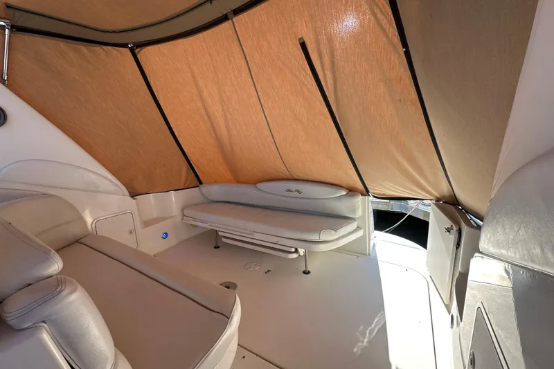 Slide: The Image of Interior of 2000 Sea Ray 340 Sundancer boat with beige seating and canopy. - 16