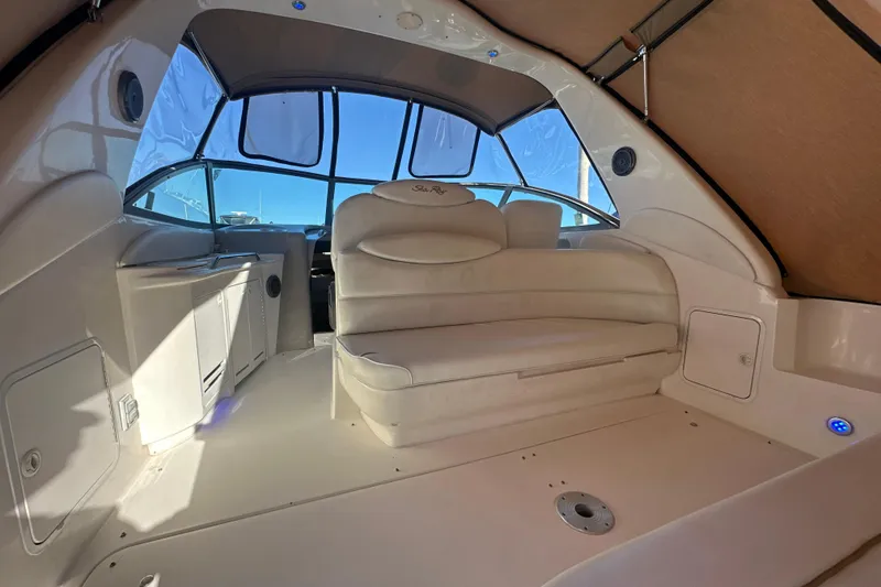 Slide: The Image of Interior of 2000 Sea Ray 340 Sundancer yacht with beige seating and canopy. - 17
