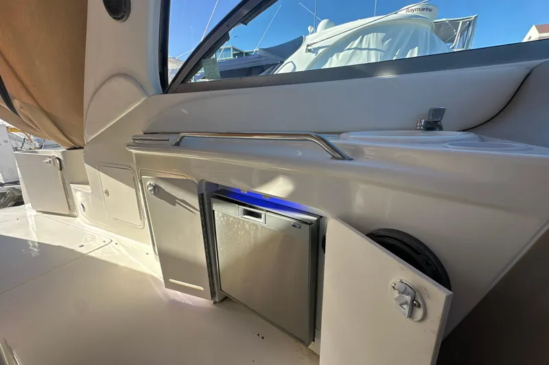 Slide: The Image of 2000 Sea Ray 340 Sundancer interior with open mini fridge and sink. - 19