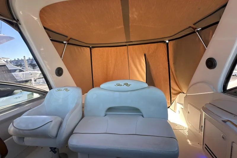 Slide: The Image of Interior of a 2000 Sea Ray 340 Sundancer with white seating and tan canopy. - 22
