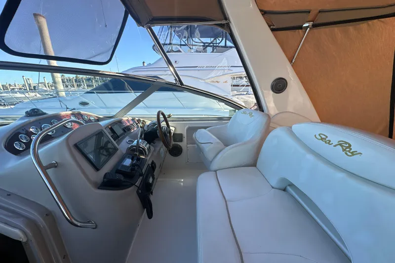 Slide: The Image of Cockpit of 2000 Sea Ray 340 Sundancer with steering wheel and control panel. - 23