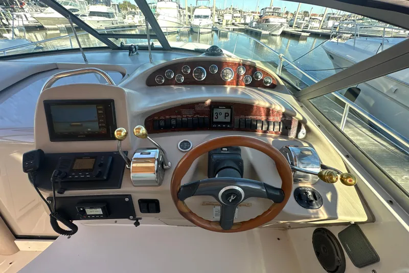 Slide: The Image of Cockpit of 2000 Sea Ray 340 Sundancer with steering wheel and control panel. - 25