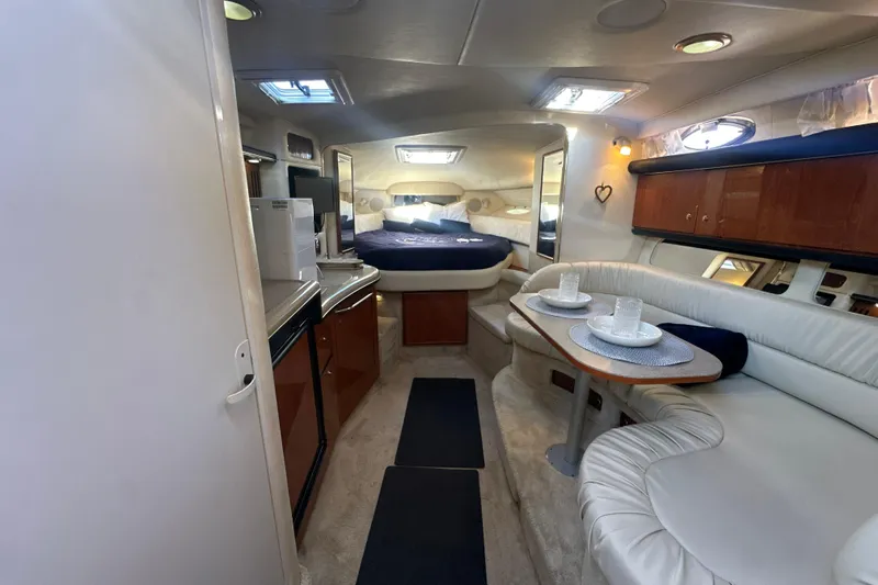Slide: The Image of Interior of 2000 Sea Ray 340 Sundancer yacht with cozy seating and dining area. - 27