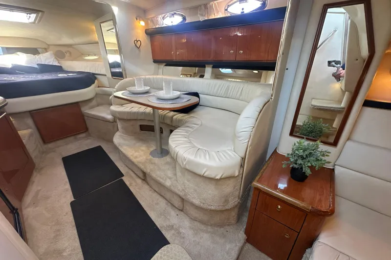 Slide: The Image of Interior of 2000 Sea Ray 340 Sundancer yacht with cozy seating and dining area. - 28