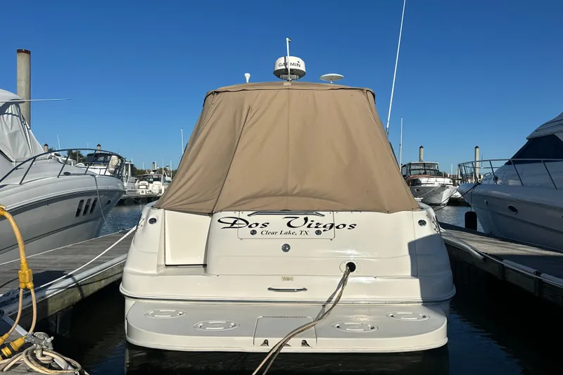 Slide: The Image of 2000 Sea Ray 340 Sundancer docked, covered, with clear blue sky background. - 3