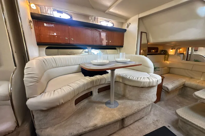 Slide: The Image of Luxurious interior of 2000 Sea Ray 340 Sundancer yacht with plush seating and dining area. - 30