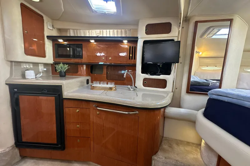 Slide: The Image of Interior of 2000 Sea Ray 340 Sundancer yacht with kitchenette and modern amenities. - 32
