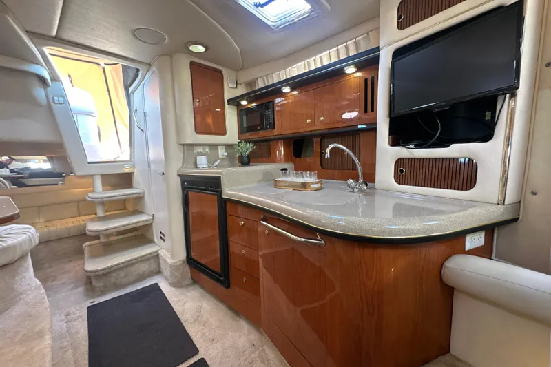 Slide: The Image of Interior of 2000 Sea Ray 340 Sundancer yacht with kitchenette and TV. - 33