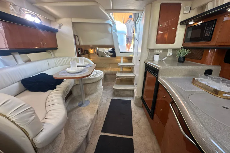 Slide: The Image of Interior of 2000 Sea Ray 340 Sundancer yacht with kitchen and seating area. - 34