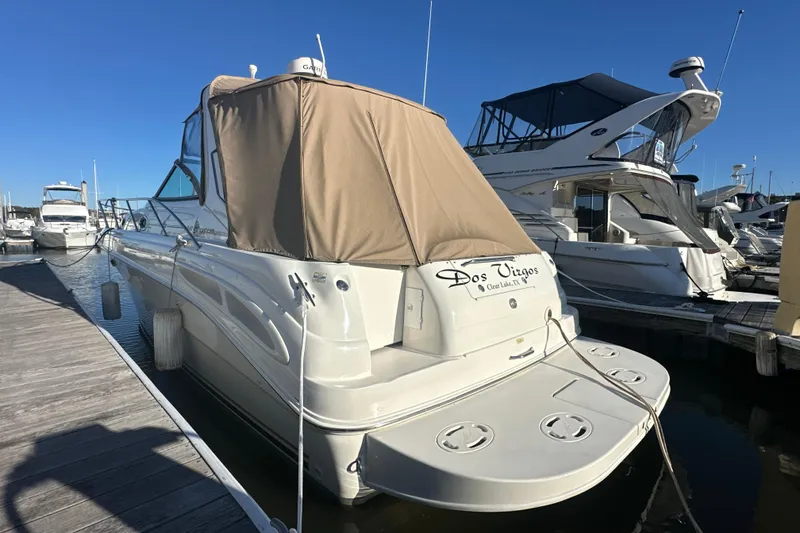 Slide: The Image of 2000 Sea Ray 340 Sundancer docked at marina, beige canopy, sunny day. - 4