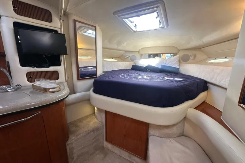 Slide: The Image of Luxurious interior of 2000 Sea Ray 340 Sundancer yacht with cozy bed and TV. - 40