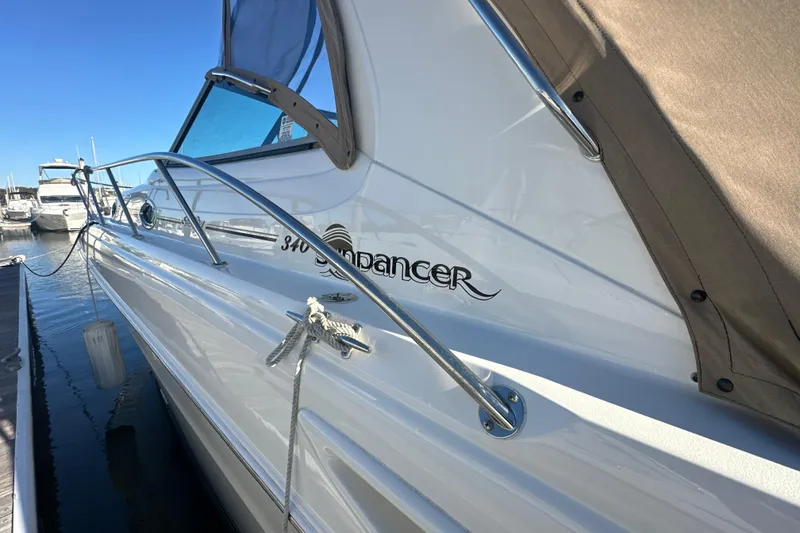 Slide: The Image of 2000 Sea Ray 340 Sundancer yacht docked, showcasing sleek design and branding. - 5