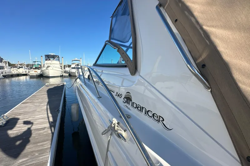 Slide: The Image of 2000 Sea Ray 340 Sundancer docked at marina under clear blue sky. - 6