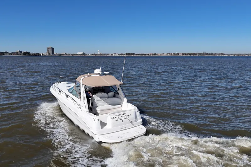 Slide: The Image of 2000 Sea Ray 340 Sundancer cruising on open water under clear blue sky. - 7
