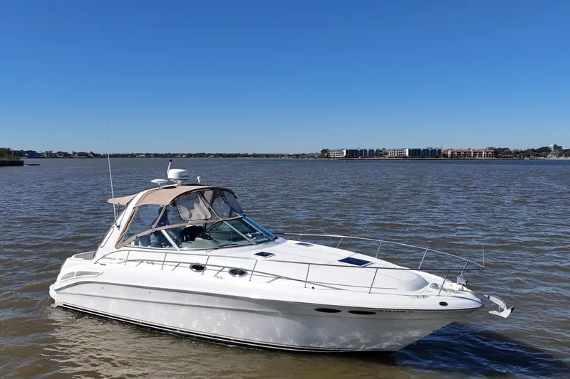 Slide: The Image of 2000 Sea Ray 340 Sundancer boat on calm water under clear blue sky. - 8