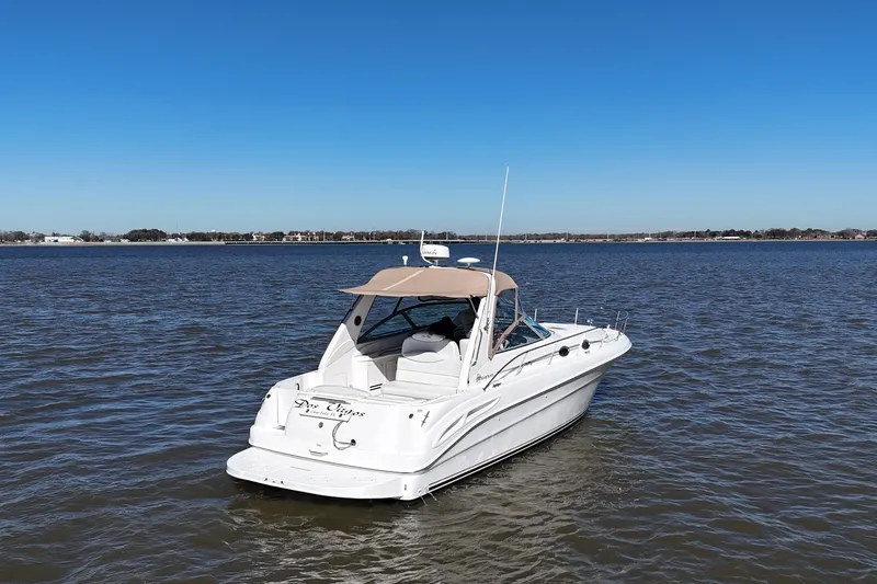 Slide: The Image of 2000 Sea Ray 340 Sundancer boat on calm water under clear blue sky. - 9