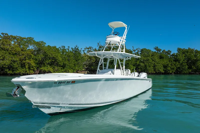 Slide: The Image of 2019 Jupiter 38 HFS boat on clear water with lush green background. - 101