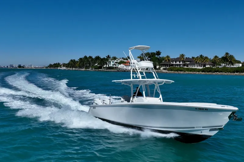 Slide: The Image of 2019 Jupiter 38 HFS boat cruising on clear blue water near a tropical shoreline. - 12
