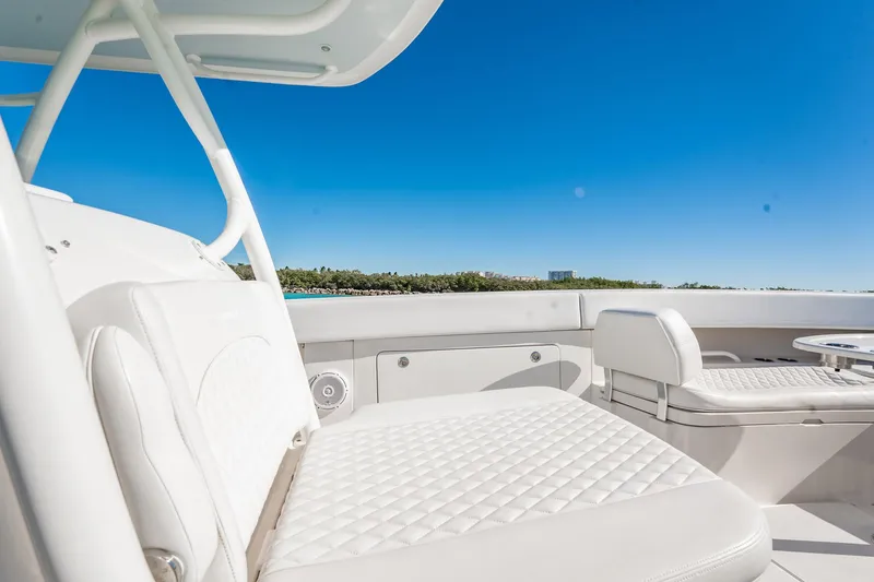 Slide: The Image of 2019 Jupiter 38 HFS boat interior with white seating and clear blue sky. - 19