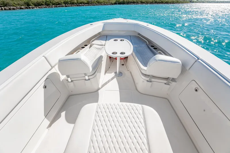 Slide: The Image of Luxurious 2019 Jupiter 38 HFS boat interior with white seating and turquoise water backdrop. - 21