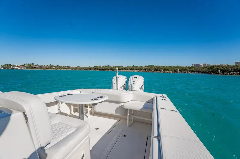 Slide: The Image of 2019 Jupiter 38 HFS boat on turquoise water with clear blue sky. - 24