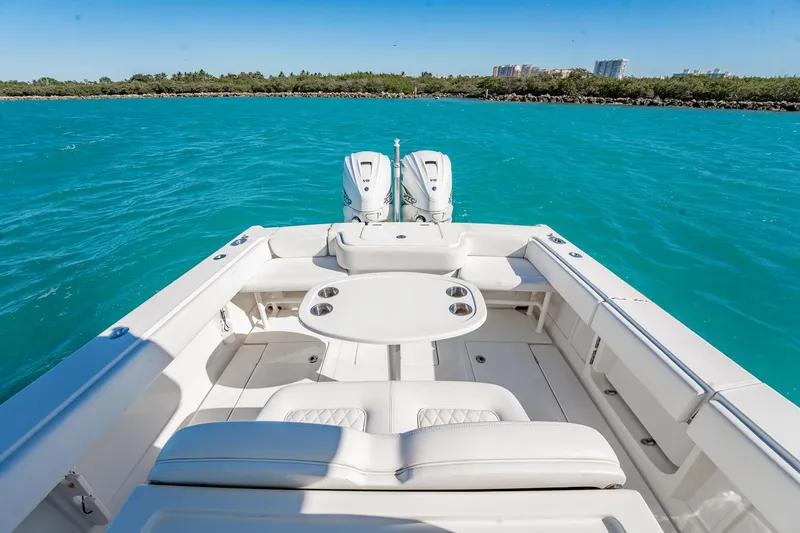 Slide: The Image of 2019 Jupiter 38 HFS boat on turquoise water, featuring spacious seating and dual engines. - 25