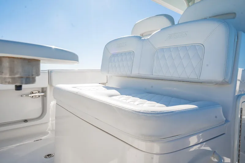 Slide: The Image of Luxurious seating on 2019 Jupiter 38 HFS boat with white upholstery and diamond stitching. - 26