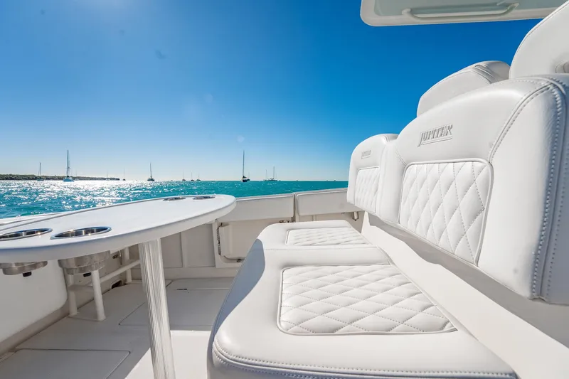 Slide: The Image of Luxurious seating on 2019 Jupiter 38 HFS boat with ocean view and clear blue sky. - 30