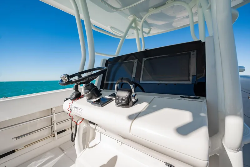 Slide: The Image of 2019 Jupiter 38 HFS boat helm with steering wheel and navigation screens. - 32