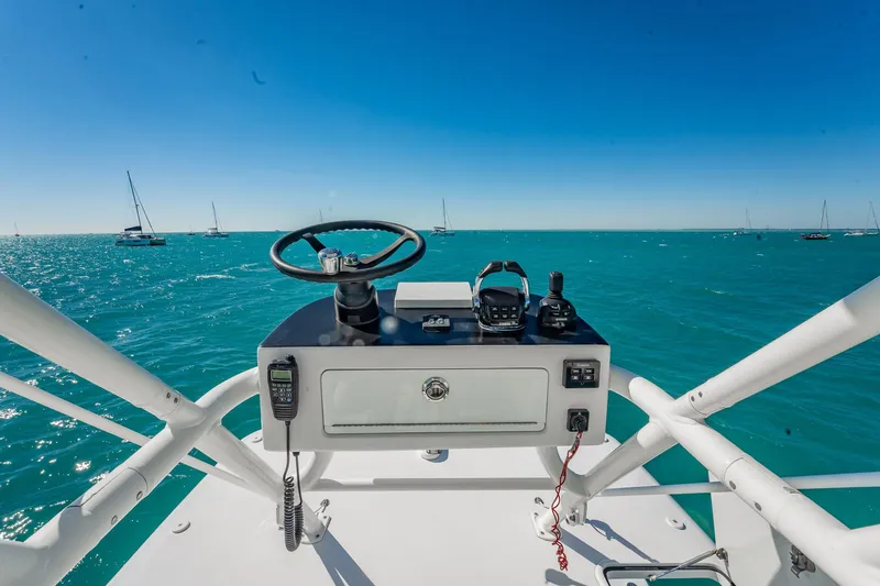 Slide: The Image of Helm of 2019 Jupiter 38 HFS boat with ocean view and sailboats. - 40