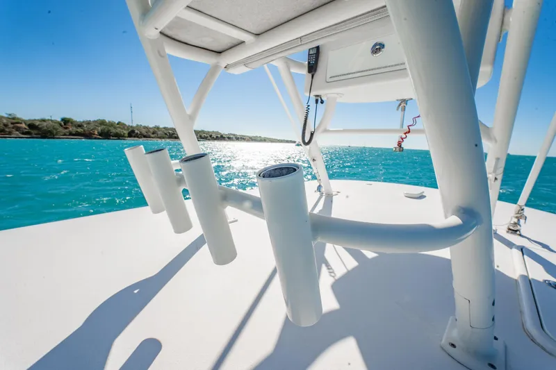 Slide: The Image of 2019 Jupiter 38 HFS boat on turquoise water, featuring rod holders and clear blue sky. - 42
