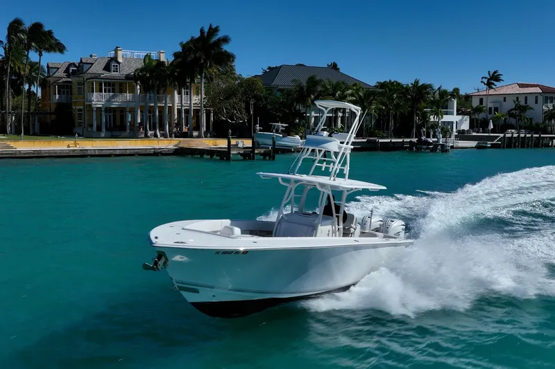 Slide: The Image of 2019 Jupiter 38 HFS boat cruising on turquoise water near luxury waterfront homes. - 45