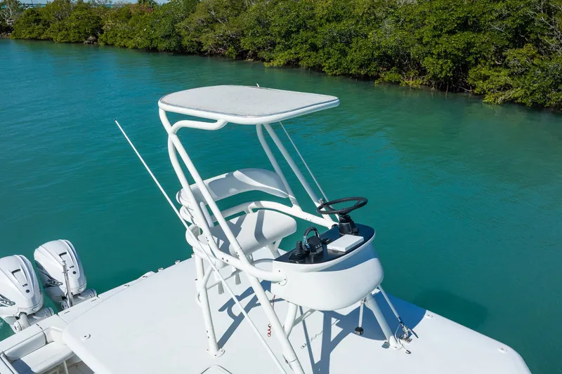 Slide: The Image of 2019 Jupiter 38 HFS boat with elevated helm, cruising on turquoise water. - 51
