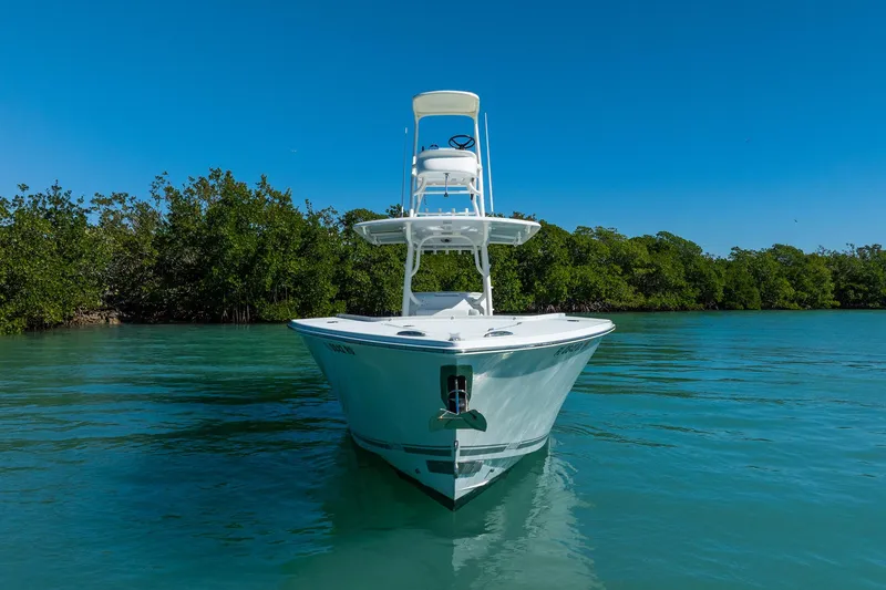 Slide: The Image of 2019 Jupiter 38 HFS boat on calm water, surrounded by lush greenery. - 57