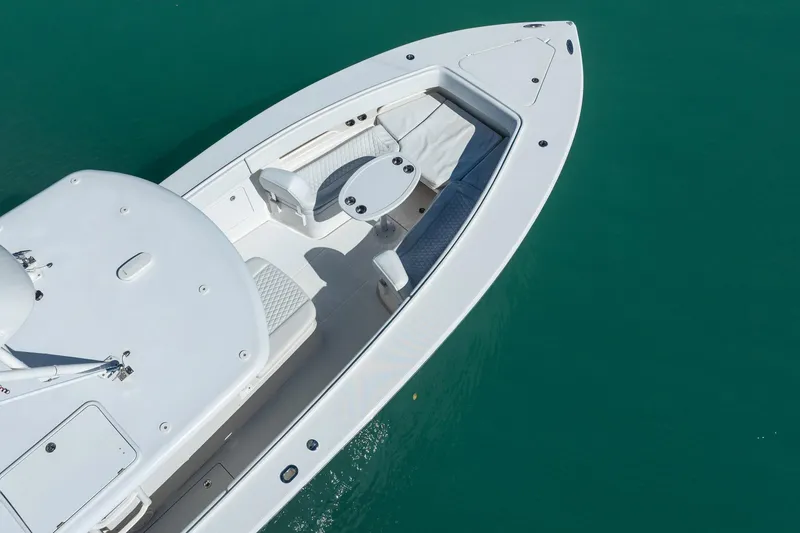 Slide: The Image of 2019 Jupiter 38 HFS boat with sleek white deck on turquoise water. - 60