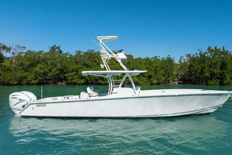 Slide: The Image of 2019 Jupiter 38 HFS boat on clear water with lush green background. - 63