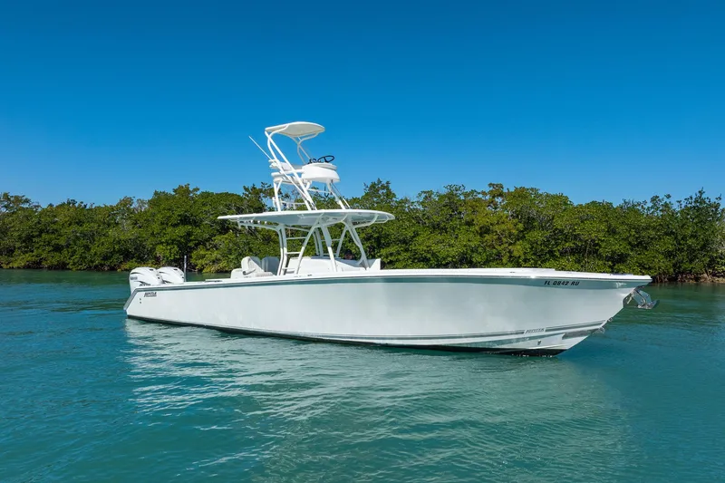 Slide: The Image of 2019 Jupiter 38 HFS boat on clear water with lush green background. - 64