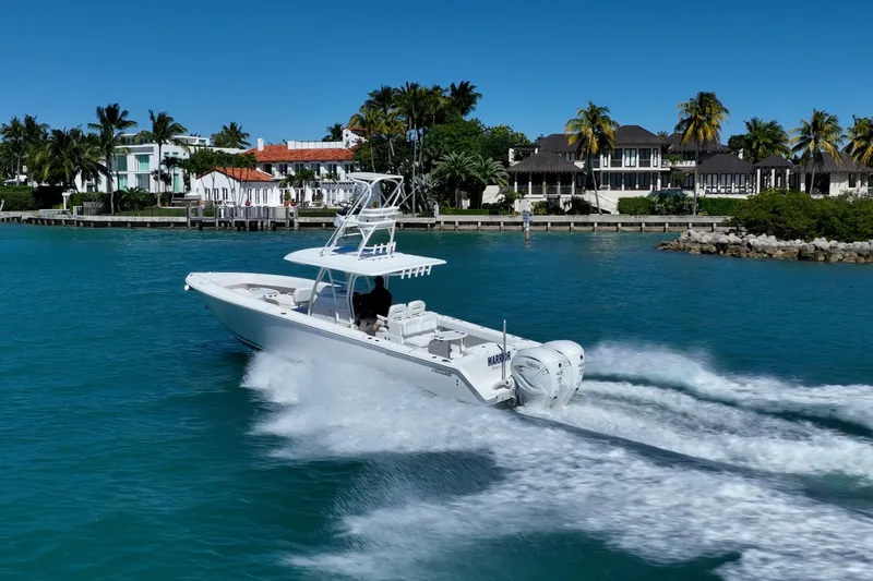 Slide: The Image of 2019 Jupiter 38 HFS boat cruising in tropical waters near luxury waterfront homes. - 68