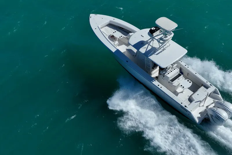Slide: The Image of Aerial view of 2019 Jupiter 38 HFS boat cruising on turquoise water. - 7