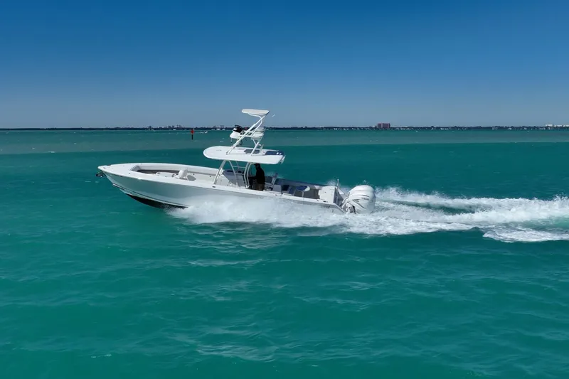 Slide: The Image of 2019 Jupiter 38 HFS boat cruising on turquoise water under clear blue sky. - 70