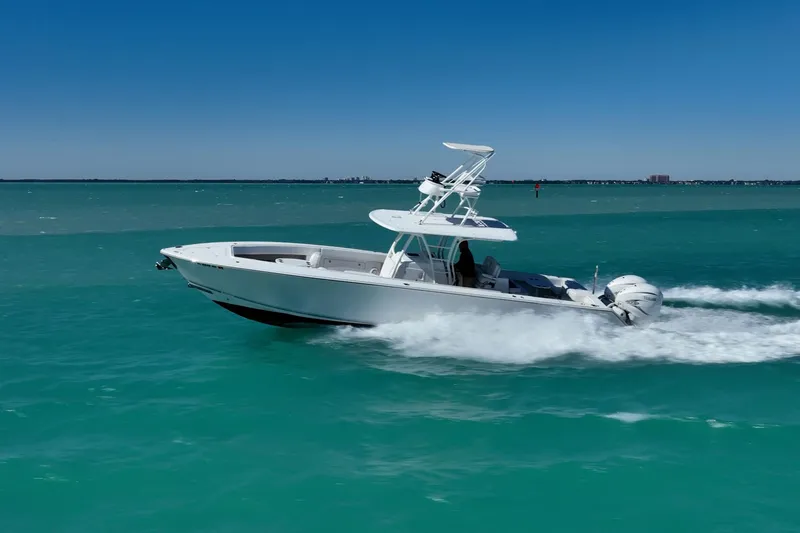 Slide: The Image of 2019 Jupiter 38 HFS boat cruising on turquoise water under clear blue sky. - 71