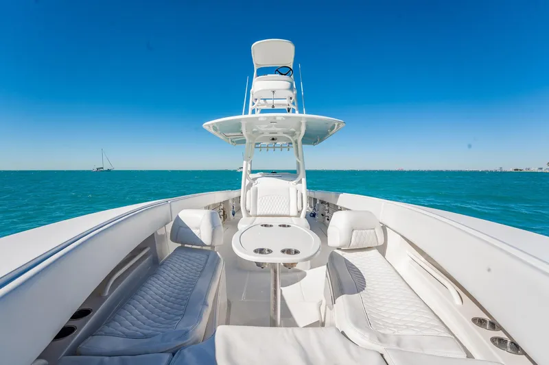 Slide: The Image of 2019 Jupiter 38 HFS boat with luxurious seating on open water under clear blue sky. - 83